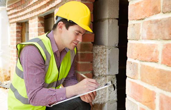 HPG Insurance Works - property maintenance image of insurance assessor assessing a damaged home.